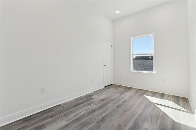 empty room with wood finished floors and baseboards