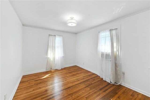 unfurnished room with baseboards and hardwood / wood-style floors