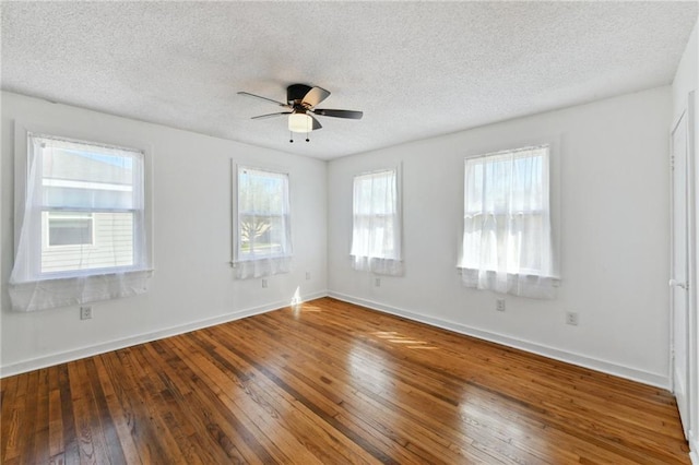 unfurnished room with baseboards, wood-type flooring, and a ceiling fan