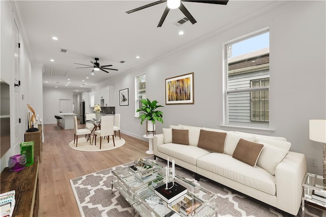 2764 Lavender St, New Orleans, LA 70122 - living room featuring a ceiling fan, crown molding, plenty of natural light, recessed lighting, and light wood-type flooring
