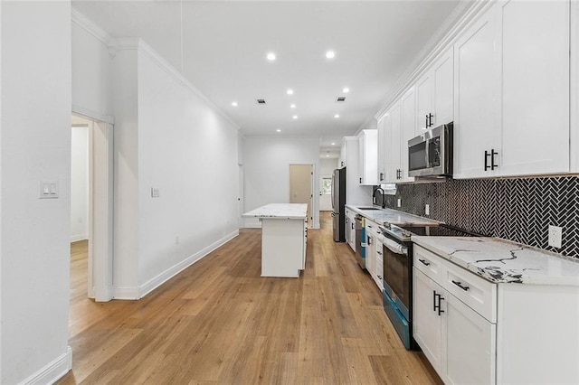 2764 Lavender St, New Orleans, LA 70122 - kitchen featuring stainless steel appliances, a sink, white cabinetry, backsplash, and recessed lighting