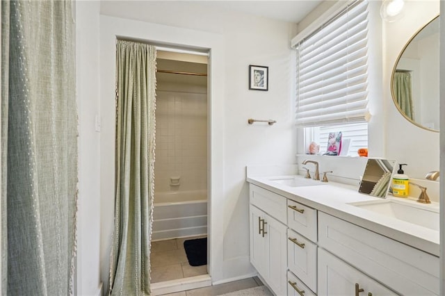 bathroom featuring a sink, double vanity, and tile patterned flooring