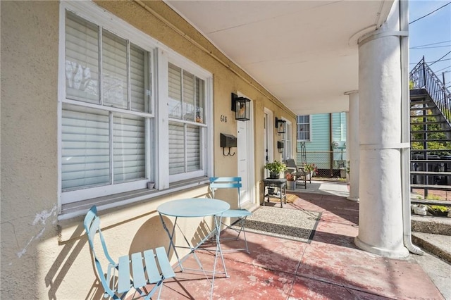 view of patio with covered porch and stairs