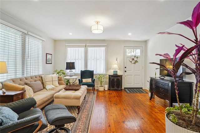 living area featuring recessed lighting and hardwood / wood-style flooring