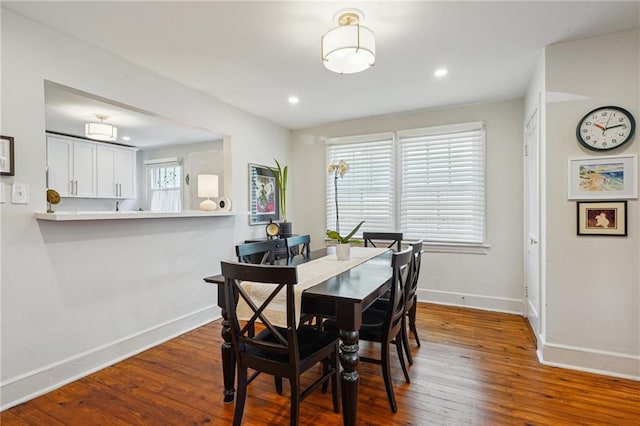 dining area featuring recessed lighting, baseboards, and hardwood / wood-style flooring