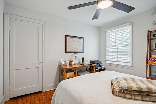 bedroom featuring baseboards, a ceiling fan, and wood finished floors