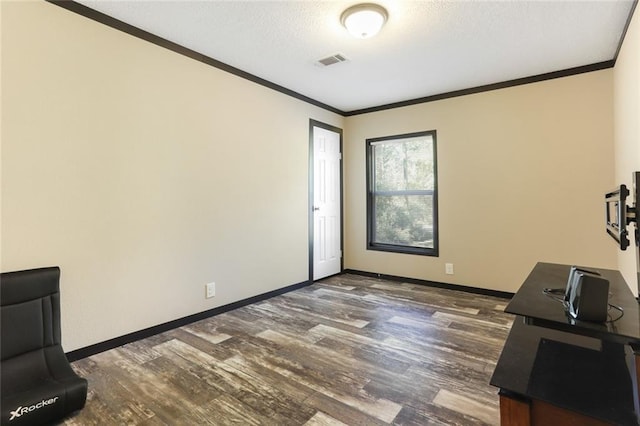 unfurnished office with baseboards, ornamental molding, dark wood-type flooring, and visible vents