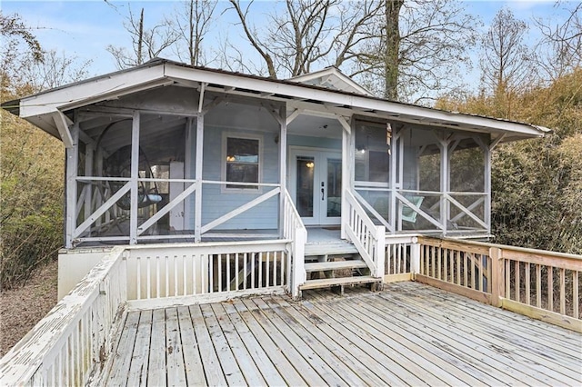 deck featuring french doors and a sunroom