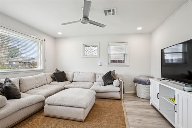 living room featuring light wood finished floors, visible vents, baseboards, ceiling fan, and recessed lighting