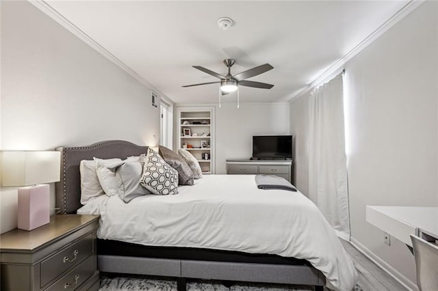 bedroom with a ceiling fan, visible vents, wood finished floors, baseboards, and ornamental molding