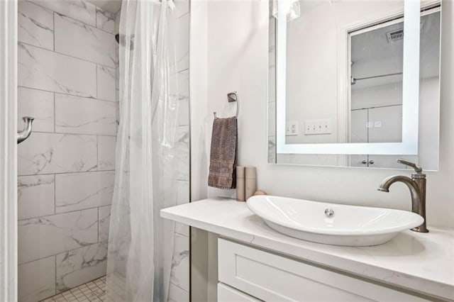 full bathroom with a stall shower and vanity