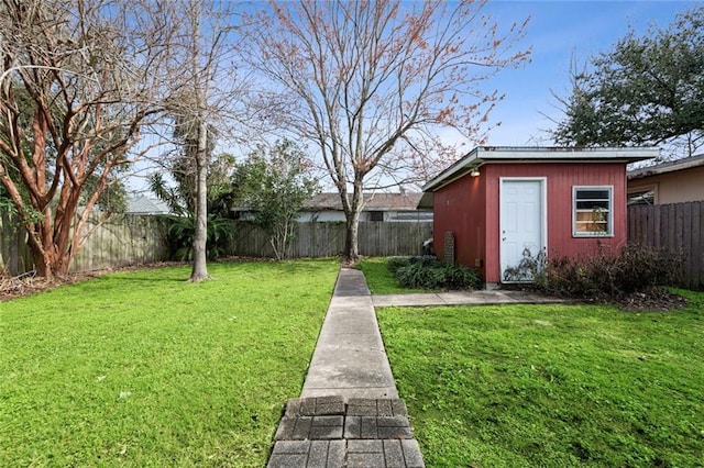 view of yard featuring an outdoor structure and a fenced backyard