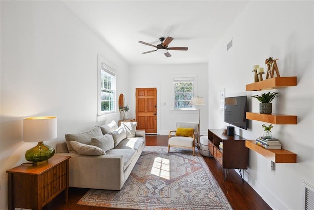 living room featuring baseboards, a healthy amount of sunlight, wood finished floors, and a ceiling fan