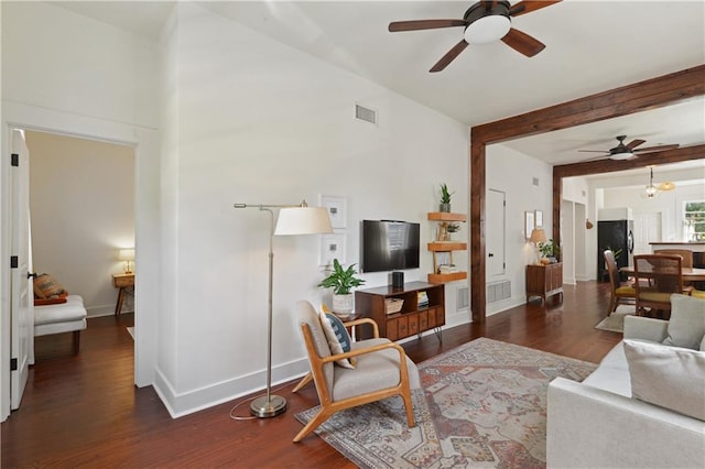 living room featuring visible vents, beamed ceiling, wood finished floors, and a ceiling fan