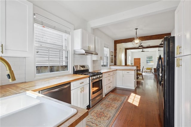 kitchen featuring beam ceiling, stainless steel appliances, a peninsula, white cabinets, and dark wood-style flooring