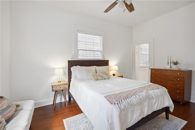 bedroom featuring wood finished floors, baseboards, and ceiling fan