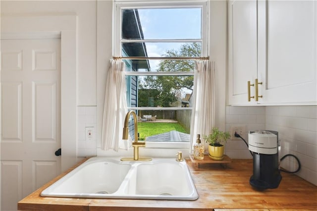 room details featuring white cabinetry and a sink