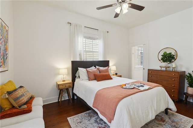 bedroom with baseboards, a ceiling fan, and dark wood-style flooring