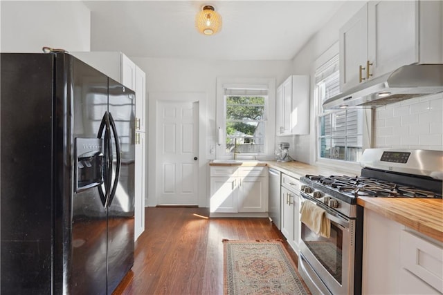 kitchen featuring under cabinet range hood, dark wood-type flooring, appliances with stainless steel finishes, and white cabinetry