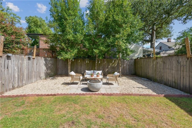 view of yard featuring a patio area, an outdoor living space with a fire pit, and a fenced backyard