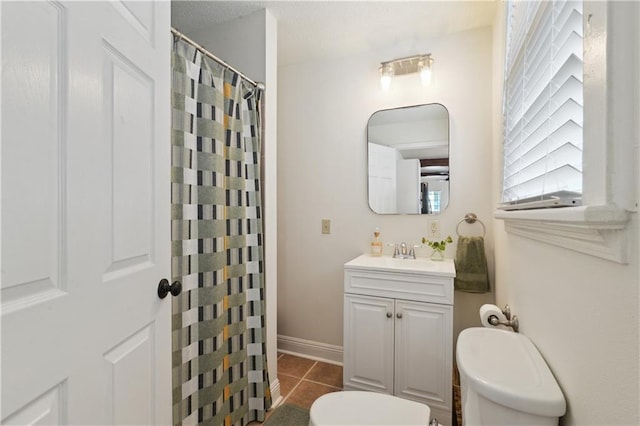 bathroom with vanity, a shower with shower curtain, baseboards, tile patterned floors, and toilet