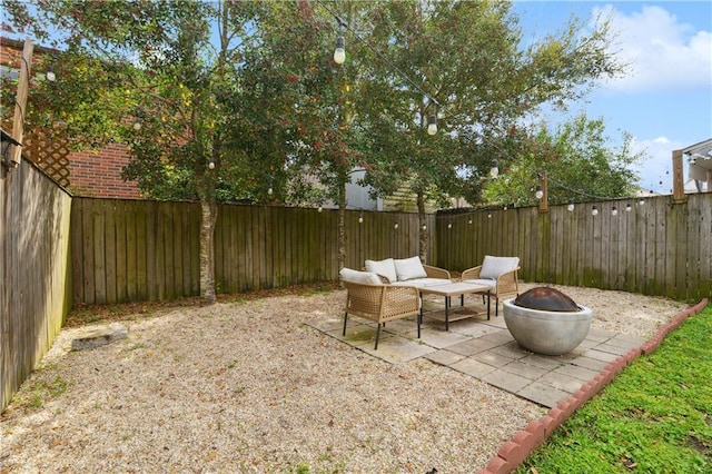 view of patio featuring an outdoor living space with a fire pit and a fenced backyard