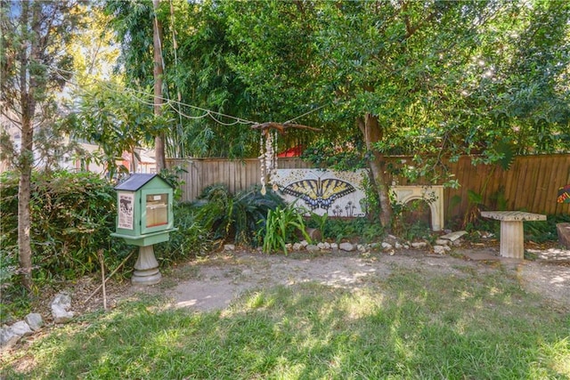 community / neighborhood sign featuring fence