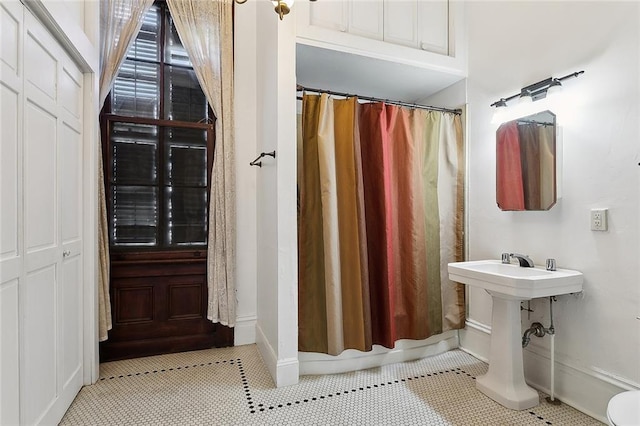 full bath with a shower with shower curtain and tile patterned floors