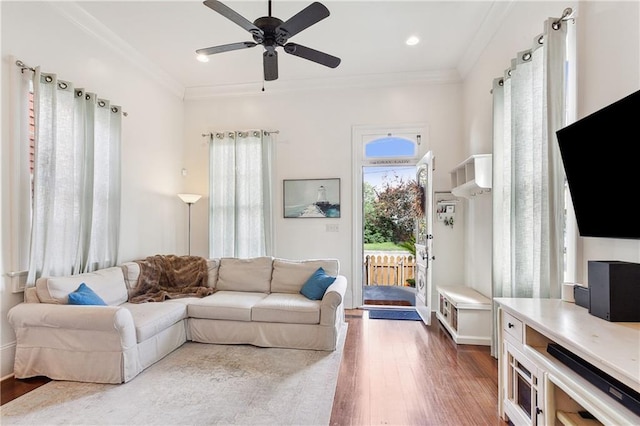 living room featuring ceiling fan, wood finished floors, ornamental molding, and recessed lighting