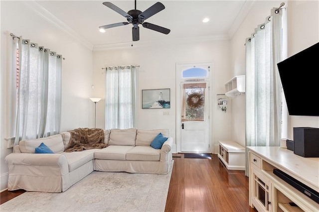 living area with dark wood-style flooring, recessed lighting, a ceiling fan, and ornamental molding