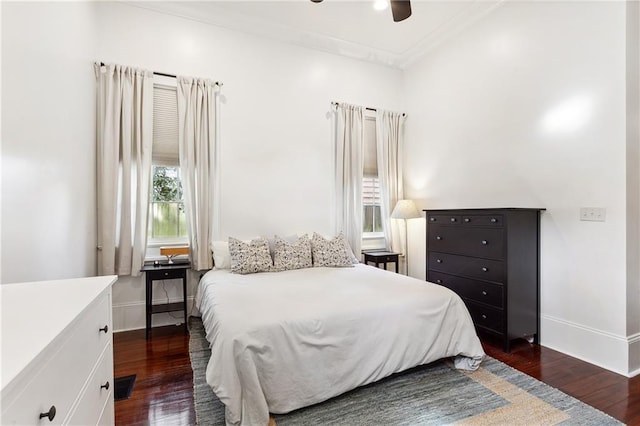 bedroom featuring baseboards, dark wood-type flooring, and ornamental molding