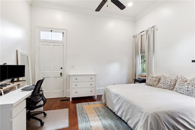 bedroom featuring dark wood-style flooring, multiple windows, a ceiling fan, and ornamental molding