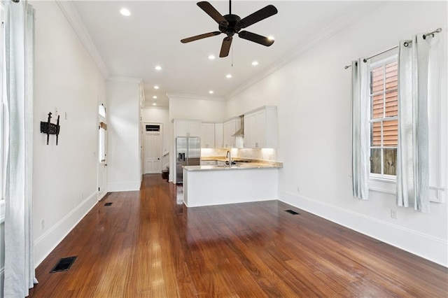 8428 Willow St, New Orleans, LA 70118 - unfurnished living room with a ceiling fan, dark wood-type flooring, ornamental molding, healthy amount of natural light, and recessed lighting