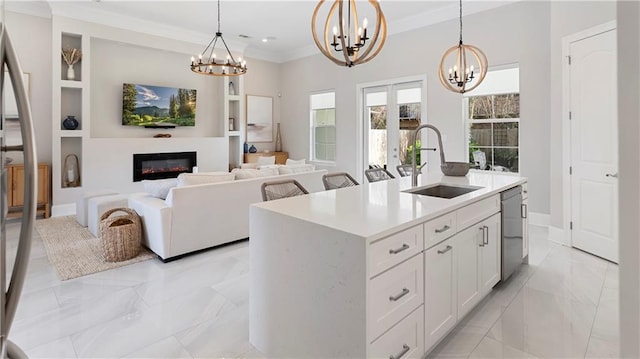 kitchen with marble finish floor, a sink, crown molding, light countertops, and dishwasher