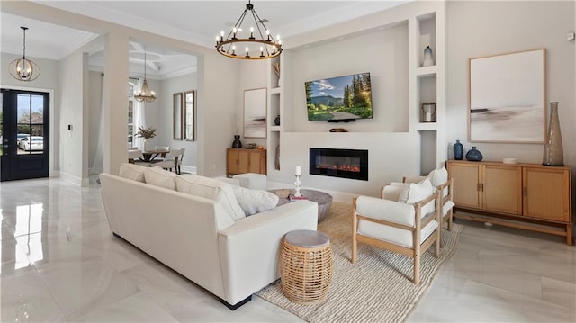 living area featuring marble finish floor, ornamental molding, a glass covered fireplace, french doors, and an inviting chandelier