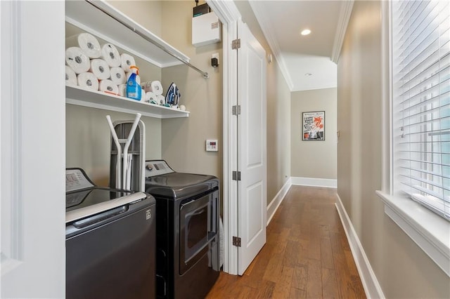 clothes washing area with baseboards, ornamental molding, recessed lighting, wood finished floors, and separate washer and dryer