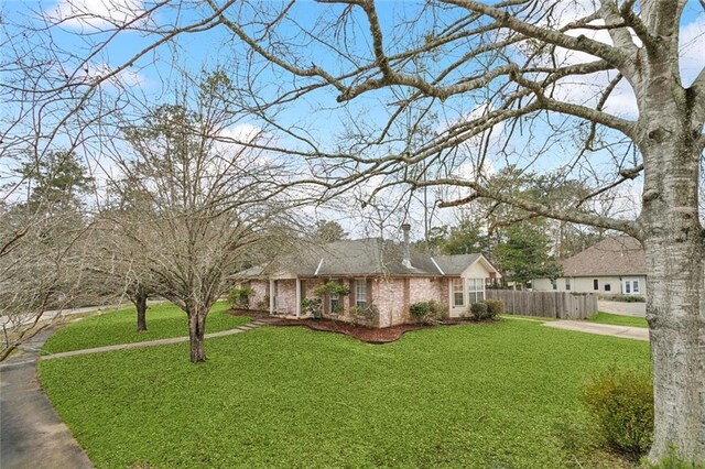 view of front of home with a front yard and fence