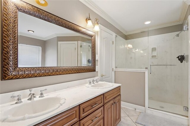 bathroom featuring a sink, ornamental molding, and a stall shower