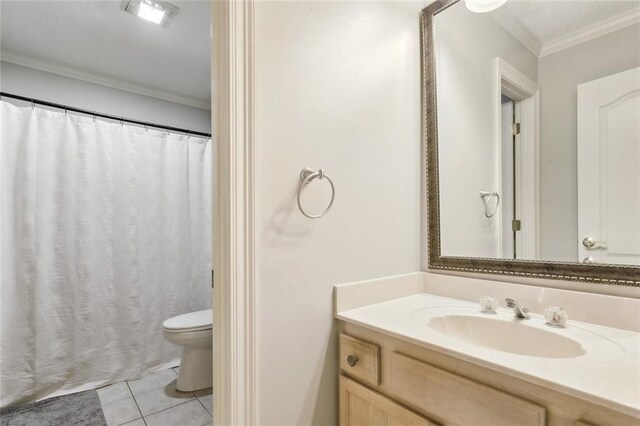 bathroom with visible vents, toilet, crown molding, vanity, and tile patterned floors