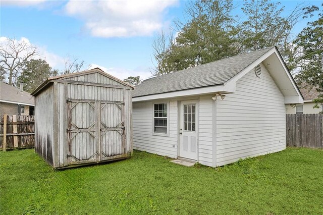view of shed featuring fence