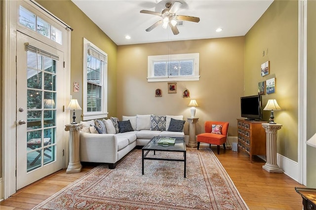 living room with light wood finished floors, recessed lighting, baseboards, and ceiling fan