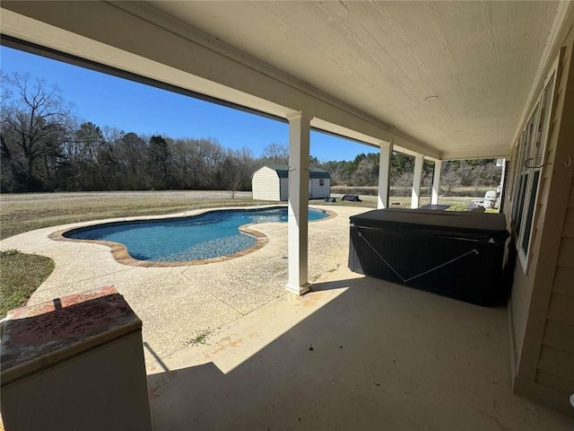 pool with a storage unit, a hot tub, an outdoor structure, and a patio area