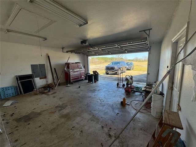 garage with electric panel and a garage door opener