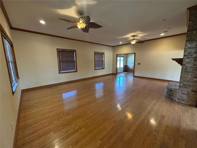 unfurnished living room with baseboards, ceiling fan, and wood finished floors