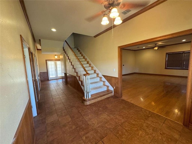 interior space featuring a ceiling fan, wood finished floors, recessed lighting, french doors, and wainscoting