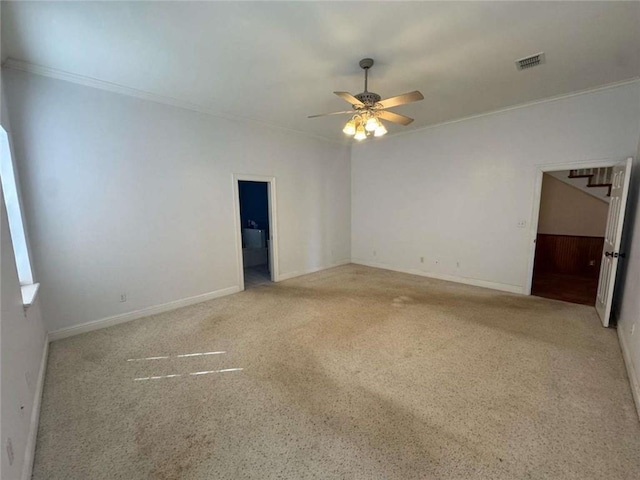 unfurnished room with visible vents, baseboards, ceiling fan, and ornamental molding