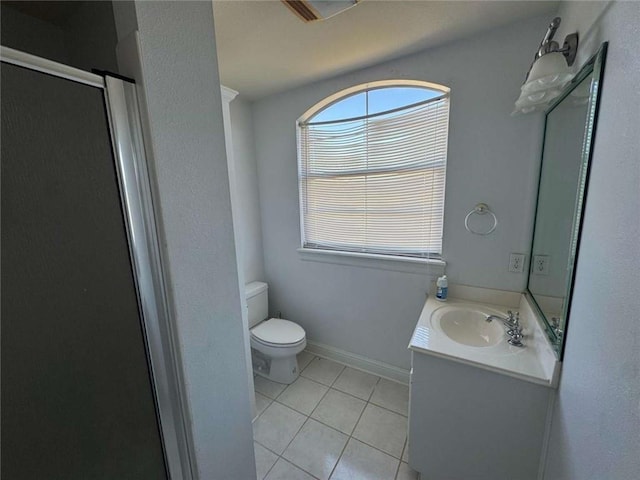 full bath featuring vanity, baseboards, a stall shower, tile patterned flooring, and toilet