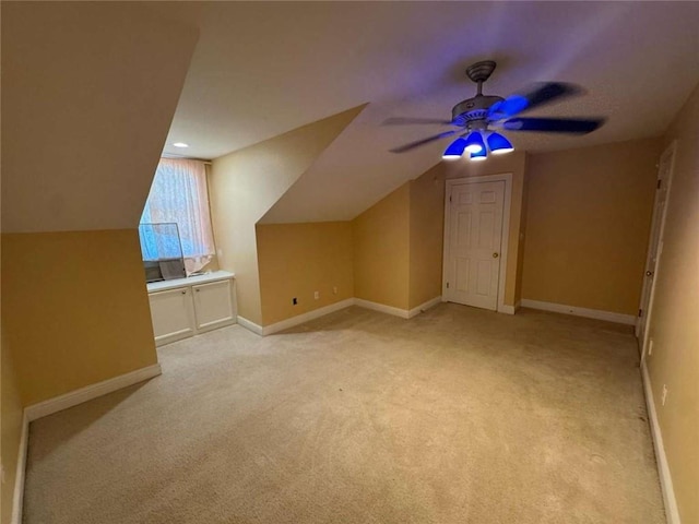 bonus room with baseboards, light colored carpet, ceiling fan, and vaulted ceiling