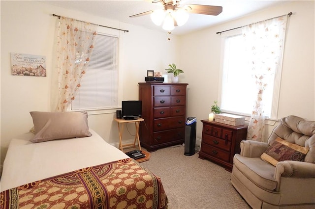 bedroom featuring light carpet and ceiling fan