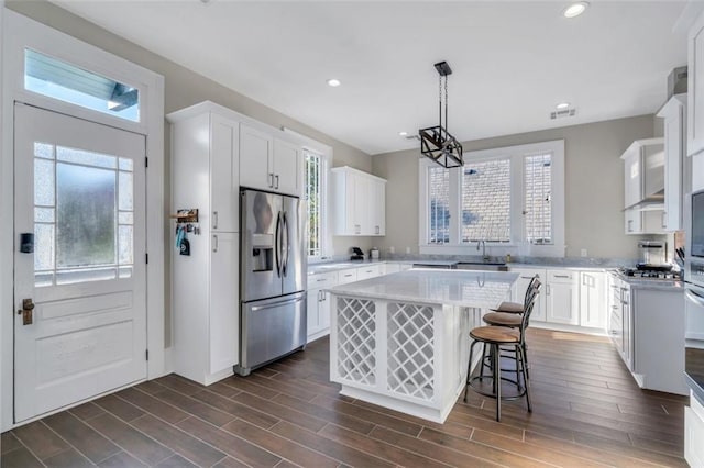 926 City Park Ave, New Orleans, LA 70119 - kitchen with wood finish floors, white cabinets, stainless steel refrigerator with ice dispenser, and light countertops